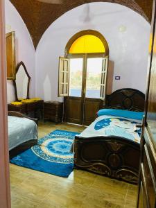Postel nebo postele na pokoji v ubytování Malika nubian house