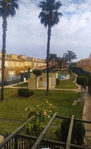 vistas a un parque con palmeras y edificios en Casa coqueta con jardin, en La Redondela