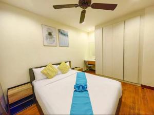 a bedroom with a bed with a blue ribbon on it at Laguna Park, BangTao Laguna in Bang Tao Beach