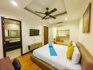 a bedroom with a bed with a ceiling fan at Laguna Park, BangTao Laguna in Bang Tao Beach