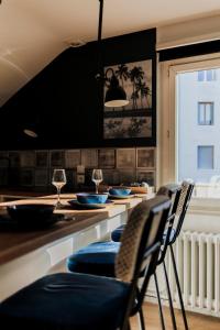 een keuken met een bar met stoelen en wijnglazen bij Loge du Pré Carré - hypercentre in Annecy