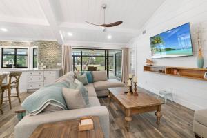 a living room with a couch and a table at Tahiti Cottage in Marco Island