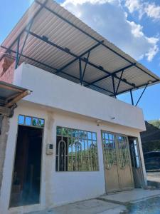 a house with a metal roof over a garage at Casa Girardot in Tocaima