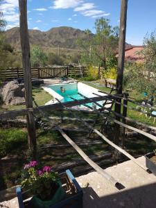 a swimming pool in a yard with a fence at Casa con piscina a 5 minutos del centro in El Challao