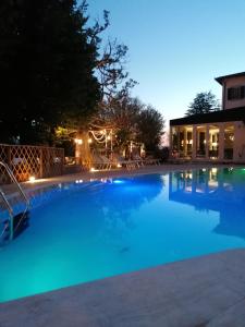 a large swimming pool at night with lights at Cortona Resort & Spa in Cortona