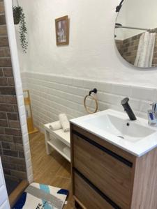 a bathroom with a sink and a mirror at Casa Alondra in El Gastor