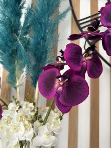 a bunch of purple and white flowers in a vase at Hotel La Voile in Bormes-les-Mimosas