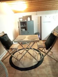 a table and two chairs in a kitchen at Studio privatif in Guillestre