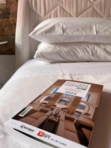 a magazine sitting on top of a bed at Casa Dos Galegos in Marvão