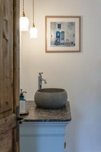 a bathroom with a stone sink on a counter at Villa Vauvert in Saignon