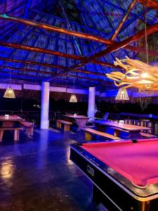 a room with ping pong tables and a large ceiling at Ka´ana Surf in El Paredón Buena Vista