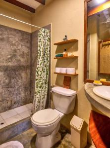 a bathroom with a toilet and a sink at Marmot Hill Apartment, loft for 2, Las Pocitas in Máncora