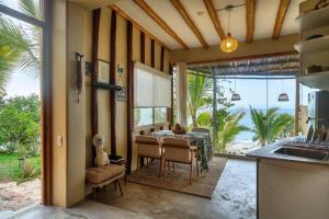 a kitchen and dining room with a table and a view of the ocean at Marmot Hill Apartment, loft for 2, Las Pocitas in Máncora