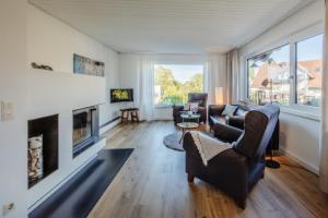 a living room filled with furniture and a fireplace at Fewo Seeschwalbe in Iznang