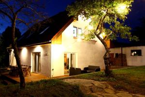 a white house with a patio at night at Dobre Miejsce in Międzyzdroje