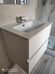 a white sink in a bathroom with a mirror at La Casa di Dany in Rome