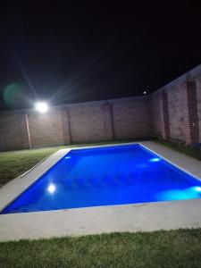 a blue swimming pool at night with a street light at Casa los ventanales in Chiconcuac