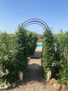 an entrance to a garden with an arched doorway at Villa Nardelli in Pozzuolo +47 photos