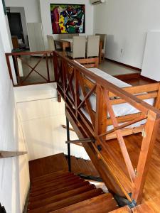 a wooden staircase in a room with a table and chairs at Apart Colon in Rufino