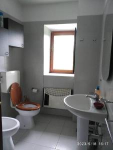 a white bathroom with a toilet and a sink at Casale immerso nel bosco a Casalborgone con piscina all'aperto in Casalborgone