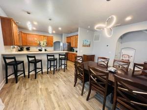 a kitchen and dining room with a table and chairs at Tropical Riverfront Paradise - Gorgeous Sunset Views in Merritt Island