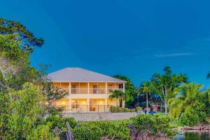 a large house with a view of the water at Tropical Riverfront Paradise - Gorgeous Sunset Views in Merritt Island