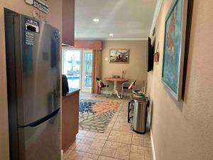 a kitchen with a refrigerator and a dining room at Guest suite - Waterfront -Pool & Hot tub- Walk to Beach in Clearwater Beach