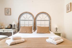 a bedroom with a large bed with two pillows on it at Demeures & Châteaux - Hôtel De La Porte Saint-Malo in Dinan