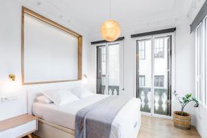 a bedroom with a bed and a large window at Home Suite Home Gran Via in Madrid