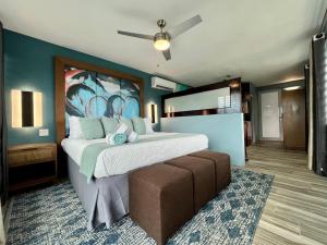 a bedroom with a large bed and a couch at Old Crow Hotel and Suites in Vieques