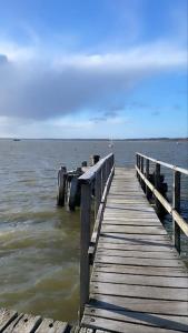 a wooden dock in the water near the ocean at Stunning 2 bed, water front Poole Quay Apartment. in Hamworthy