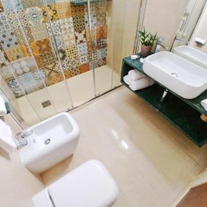 a bathroom with a sink and a toilet and a shower at Hotel Thàlas Club in Torre dell'Orso