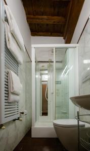 a bathroom with a glass shower and a sink at Acacia Firenze - Adelfa in Florence