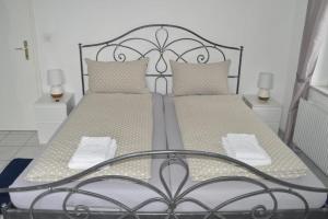 a bed with a metal frame and two pillows at Casa Carmela in Solothurn