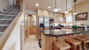 a kitchen with wooden cabinets and a counter top at Tamarack Townhomes - CoralTree Residence Collection in Snowmass Village