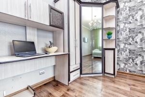 a room with a laptop on a counter with a hallway at 1 комнатная квартира в Элитном доме in Pavlodar