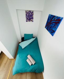 a small room with a blue bed in the corner at Apartment In Time in Sesvete