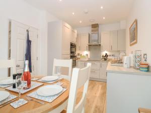 a kitchen and dining room with a table and chairs at The Hollies in Norwich