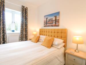 a bedroom with a large bed and a window at The Hollies in Norwich