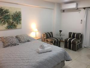 1 dormitorio con 1 cama y 2 sillas en Alquiler turistico en San Miguel de Tucumán