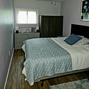 a bedroom with a large bed and a window at Bearfoot Bungalow in Sauble Beach