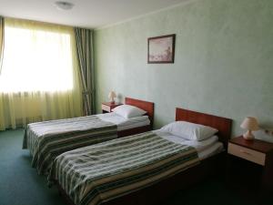Postel nebo postele na pokoji v ubytování Cherkasy Palace