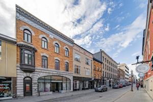 a city street with buildings and cars on the road at Heaven's Garden / / Luxury penthouse downtown in Quebec City