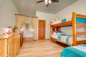 a bedroom with two bunk beds and a desk at Beach Break Hotel & Surf Camp de Playa Venao in Playa Venao