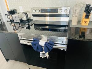 a kitchen with a stove with towels on the oven at Brand New Townhouse, min from Disney in Kissimmee