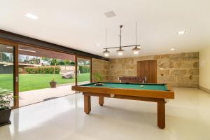 a living room with a pool table in it at Casa do Espigueiro in Chaves
