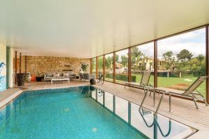 a house with a swimming pool and a living room at Casa do Espigueiro in Chaves