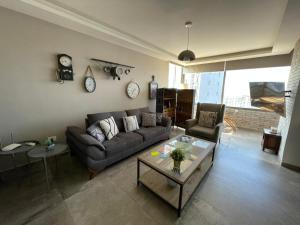 ein Wohnzimmer mit einem Sofa und einem Tisch in der Unterkunft Stunning Vacation Rental in Matn Lebanon in Dbayeh