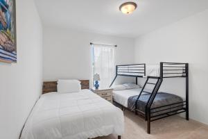 a bedroom with two bunk beds and a chair at Luxury Townhome by LSU campus in Baton Rouge