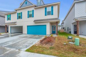 a large white house with a blue garage at Luxury Townhome by LSU campus in Baton Rouge